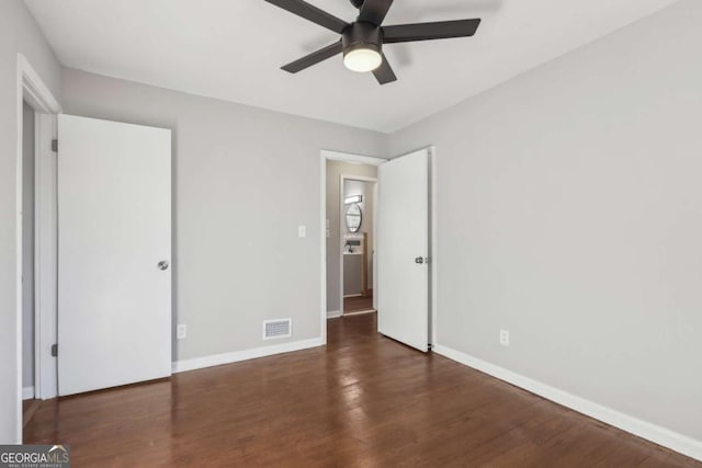 unfurnished bedroom with ceiling fan and dark hardwood / wood-style floors