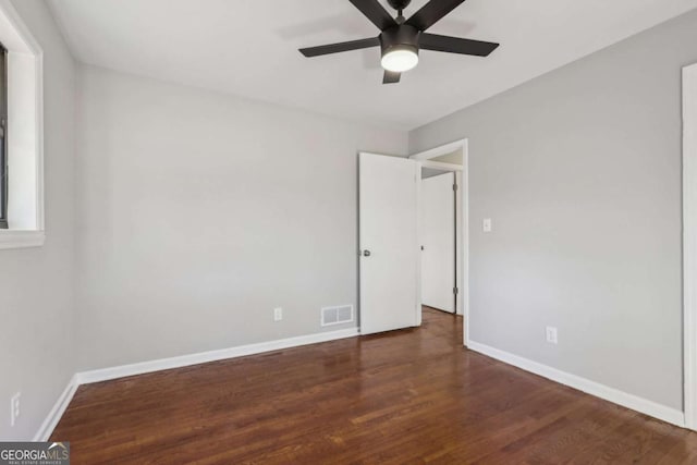 spare room with ceiling fan and dark hardwood / wood-style floors