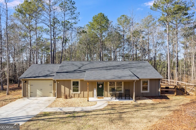 single story home with covered porch and a garage