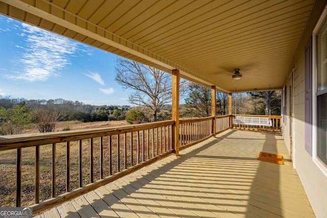 wooden deck featuring ceiling fan