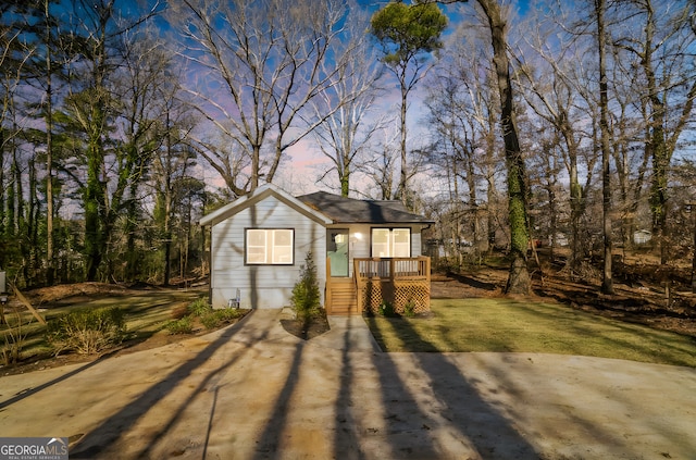 outdoor structure at dusk featuring a yard