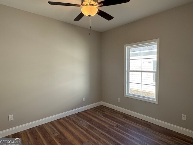 spare room with ceiling fan and dark wood-type flooring