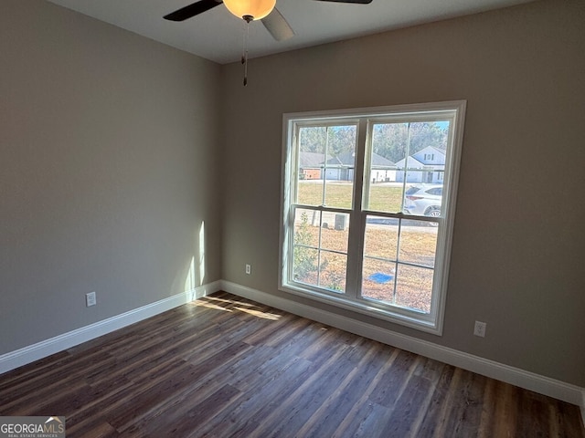 spare room featuring ceiling fan and dark hardwood / wood-style flooring