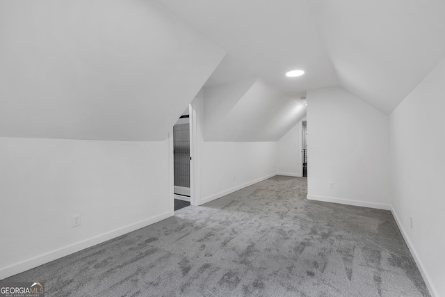 bonus room featuring lofted ceiling and carpet