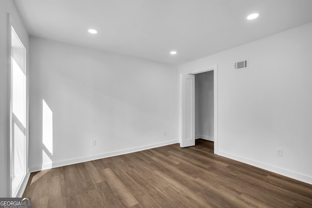 empty room featuring dark wood-type flooring