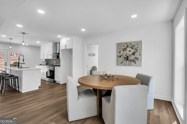 dining area featuring sink and dark hardwood / wood-style flooring