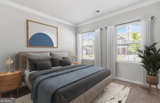 bedroom featuring crown molding and light carpet