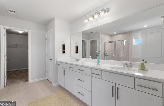 bathroom featuring tile patterned floors, walk in shower, and vanity