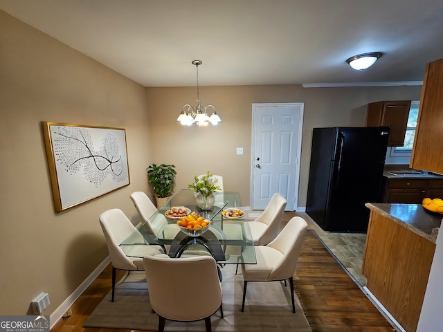 dining area with dark hardwood / wood-style flooring and a chandelier