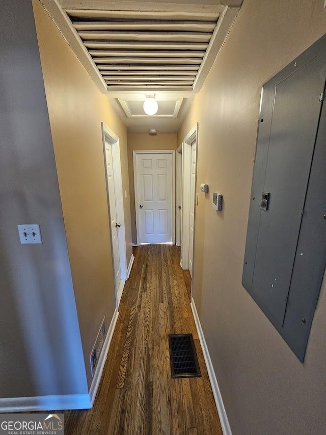 hallway with dark hardwood / wood-style floors and electric panel