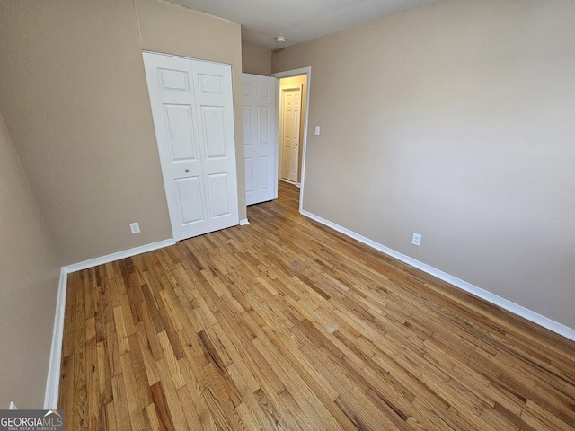 unfurnished bedroom featuring a closet and light hardwood / wood-style flooring