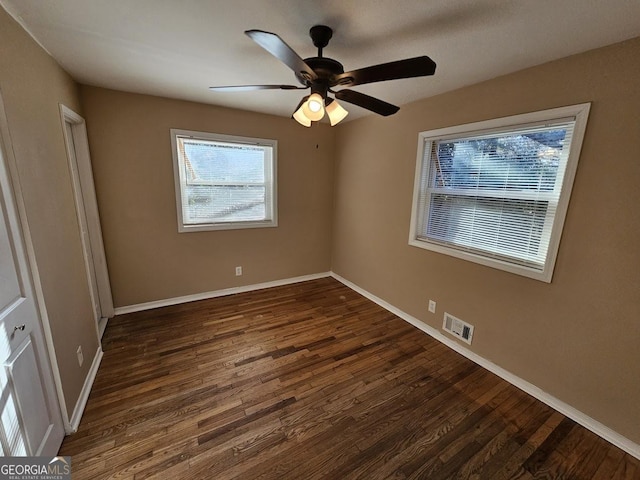 unfurnished bedroom with ceiling fan and dark hardwood / wood-style flooring