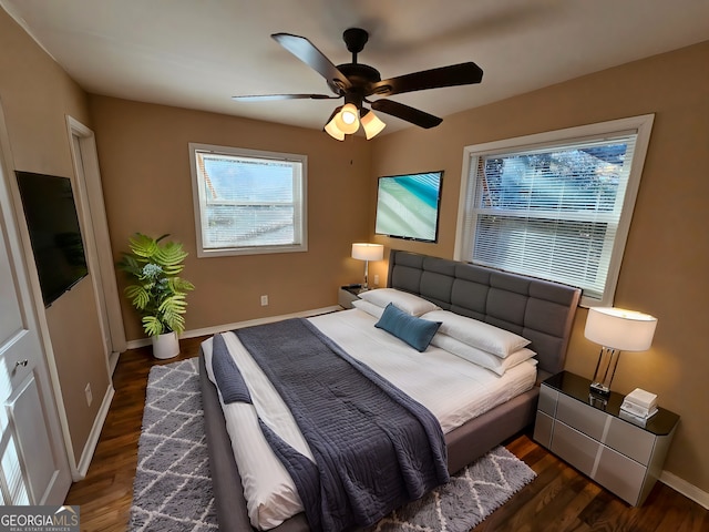 bedroom with ceiling fan and dark wood-type flooring