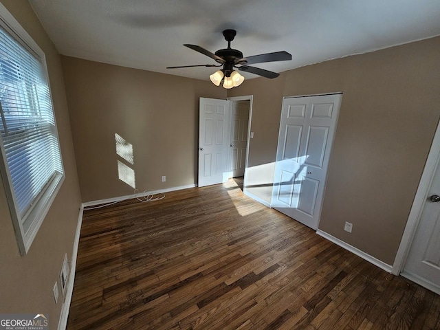 interior space with ceiling fan and dark wood-type flooring