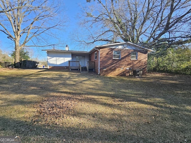 rear view of property with a yard