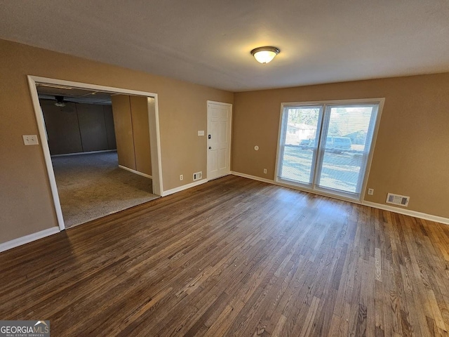 spare room with ceiling fan and dark hardwood / wood-style floors