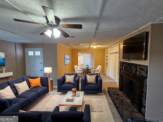 living room featuring ceiling fan and a fireplace