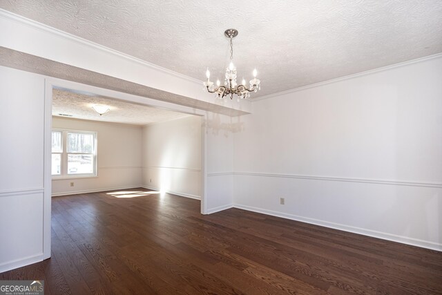 empty room with french doors, ornamental molding, a textured ceiling, and dark hardwood / wood-style floors