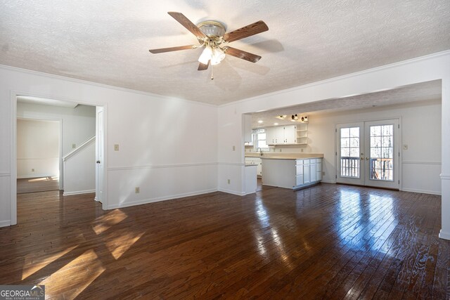 kitchen with dark hardwood / wood-style floors, black dishwasher, a healthy amount of sunlight, and white cabinets