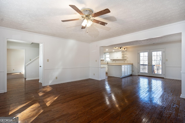 49 Post Oak Dr, Lagrange, GA 30240 - unfurnished living room with a textured ceiling, crown molding, dark wood-type flooring, a ceiling fan, and french doors