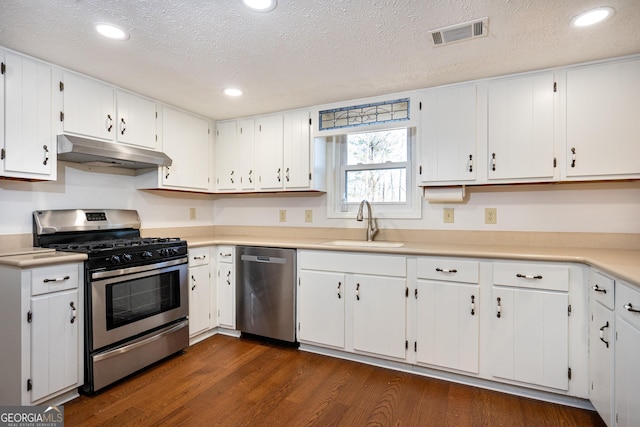 49 Post Oak Dr, Lagrange, GA 30240 - kitchen with stainless steel appliances, under cabinet range hood, a sink, dark wood-style floors, and white cabinets
