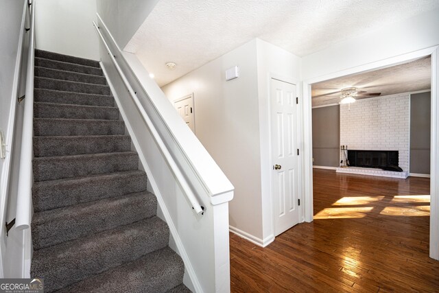 unfurnished room with a textured ceiling, ceiling fan, and carpet flooring