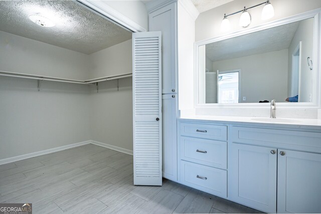 bathroom with a textured ceiling and vanity