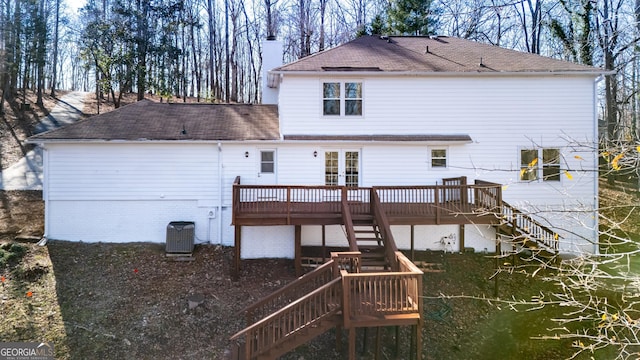 rear view of property featuring a deck and cooling unit