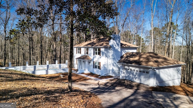 49 Post Oak Dr, Lagrange, GA 30240 - colonial house with a chimney, a shingled roof, a forest view, and a detached garage