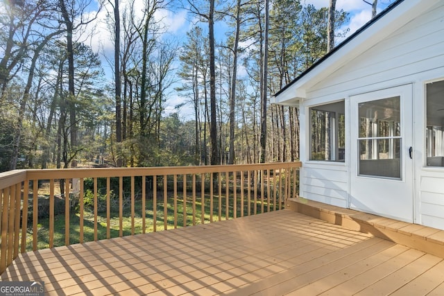 wooden deck with a sunroom and a lawn