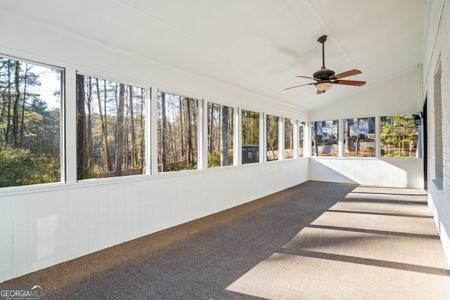 sunroom with ceiling fan, vaulted ceiling, and plenty of natural light