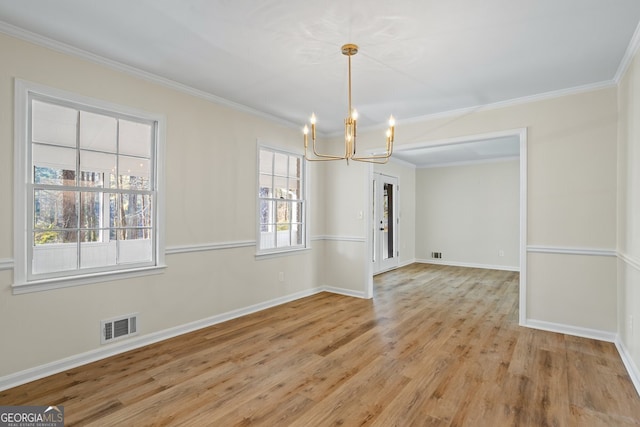 unfurnished dining area featuring crown molding, an inviting chandelier, and light hardwood / wood-style flooring