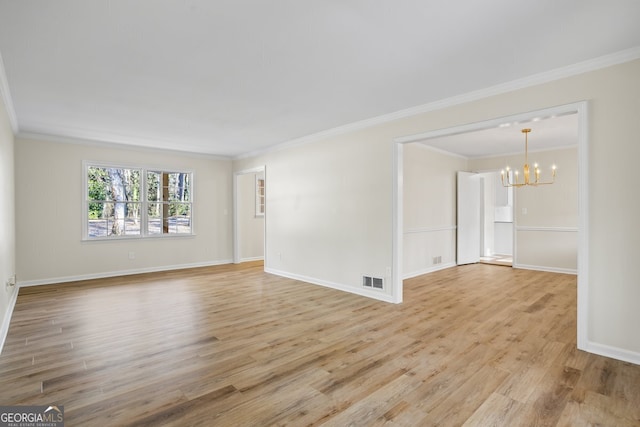 empty room featuring light hardwood / wood-style floors, crown molding, and an inviting chandelier