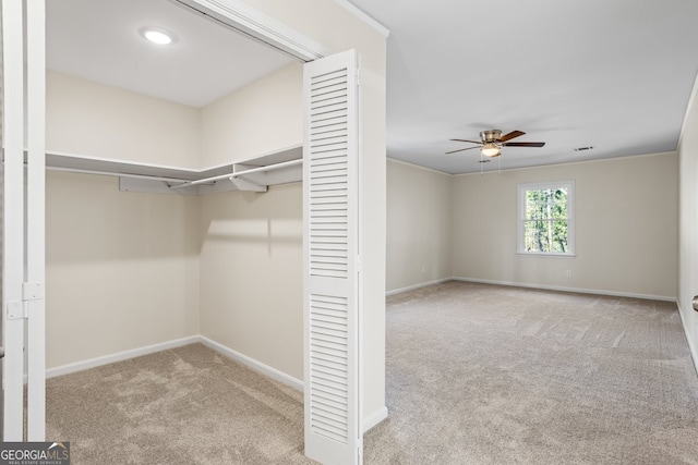 spacious closet featuring light carpet and ceiling fan