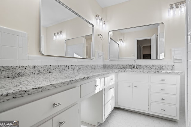 bathroom featuring vanity, tasteful backsplash, and tile patterned flooring