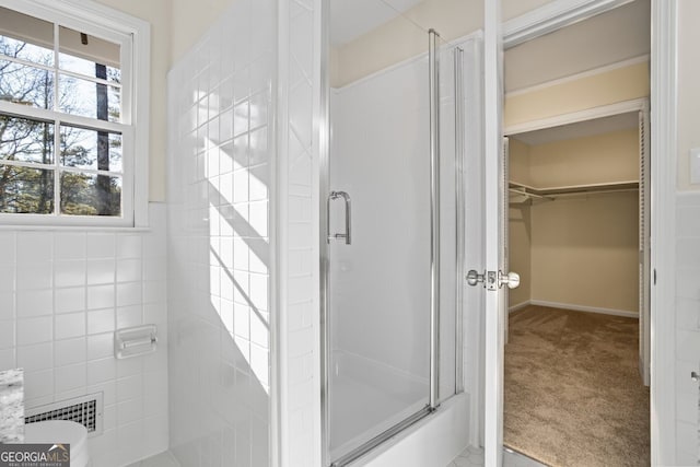 bathroom with a shower with door