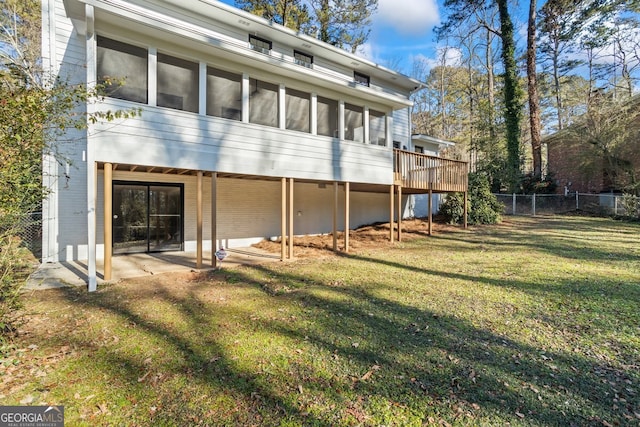 back of house featuring a patio area, a sunroom, and a yard