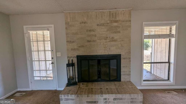 room details with a textured ceiling, a fireplace, and carpet floors