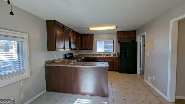 kitchen featuring dark brown cabinetry, black appliances, sink, kitchen peninsula, and light tile patterned floors