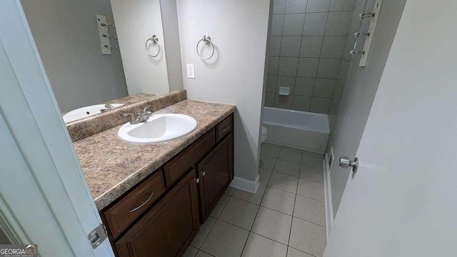 full bathroom with toilet, vanity, tile patterned flooring, and tiled shower / bath combo