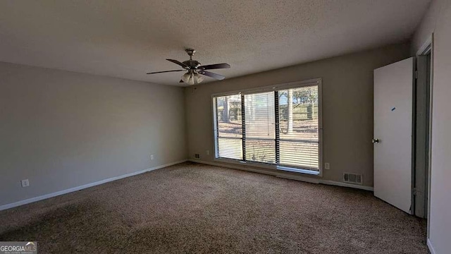 spare room featuring ceiling fan, a textured ceiling, and carpet flooring