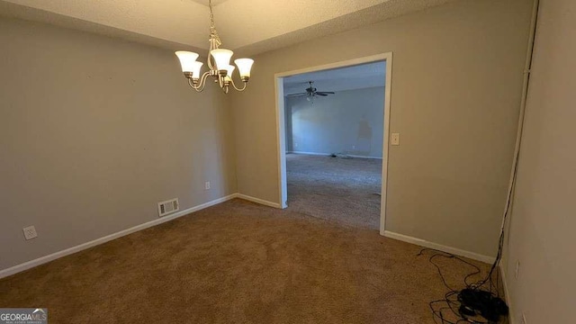 carpeted spare room with ceiling fan with notable chandelier