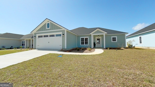 1013 Syrup Mill Creek Ln, Cairo, GA 39828 - view of front facade featuring a front lawn, a garage, board and batten siding, and driveway