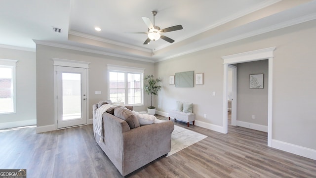 1013 Syrup Mill Creek Ln, Cairo, GA 39828 - living area featuring visible vents, ornamental molding, wood finished floors, a raised ceiling, and a ceiling fan