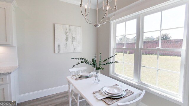 1013 Syrup Mill Creek Ln, Cairo, GA 39828 - dining space with baseboards, an inviting chandelier, and wood finished floors