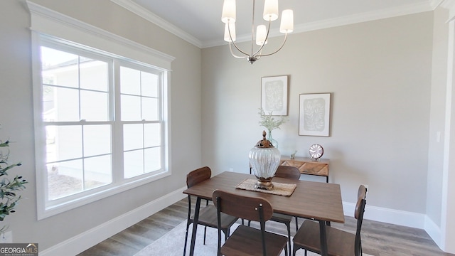 1013 Syrup Mill Creek Ln, Cairo, GA 39828 - dining space with wood finished floors, a healthy amount of sunlight, a chandelier, and crown molding