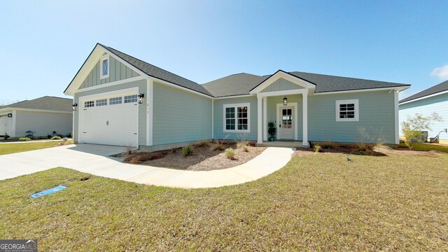 1013 Syrup Mill Creek Ln, Cairo, GA 39828 - ranch-style house featuring driveway, roof with shingles, a front lawn, a garage, and board and batten siding