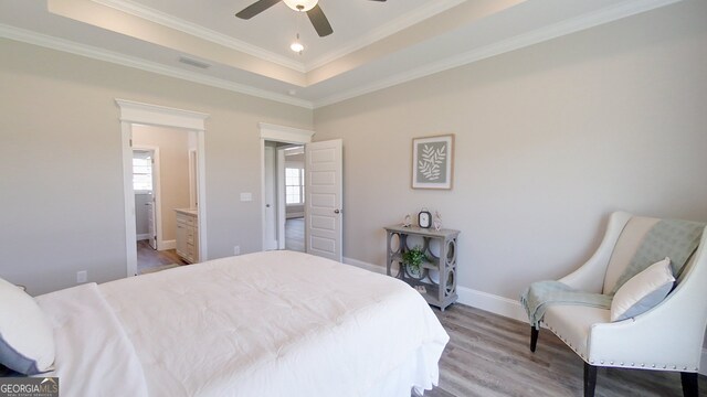 1013 Syrup Mill Creek Ln, Cairo, GA 39828 - bedroom with a raised ceiling, crown molding, light wood-style floors, and baseboards