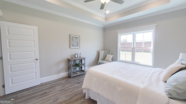 1013 Syrup Mill Creek Ln, Cairo, GA 39828 - bedroom featuring ornamental molding, a tray ceiling, wood finished floors, baseboards, and ceiling fan