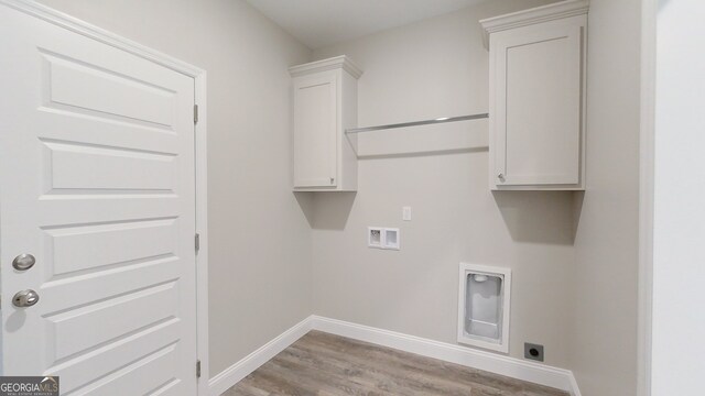 1013 Syrup Mill Creek Ln, Cairo, GA 39828 - washroom with baseboards, hookup for a washing machine, light wood-style flooring, cabinet space, and electric dryer hookup